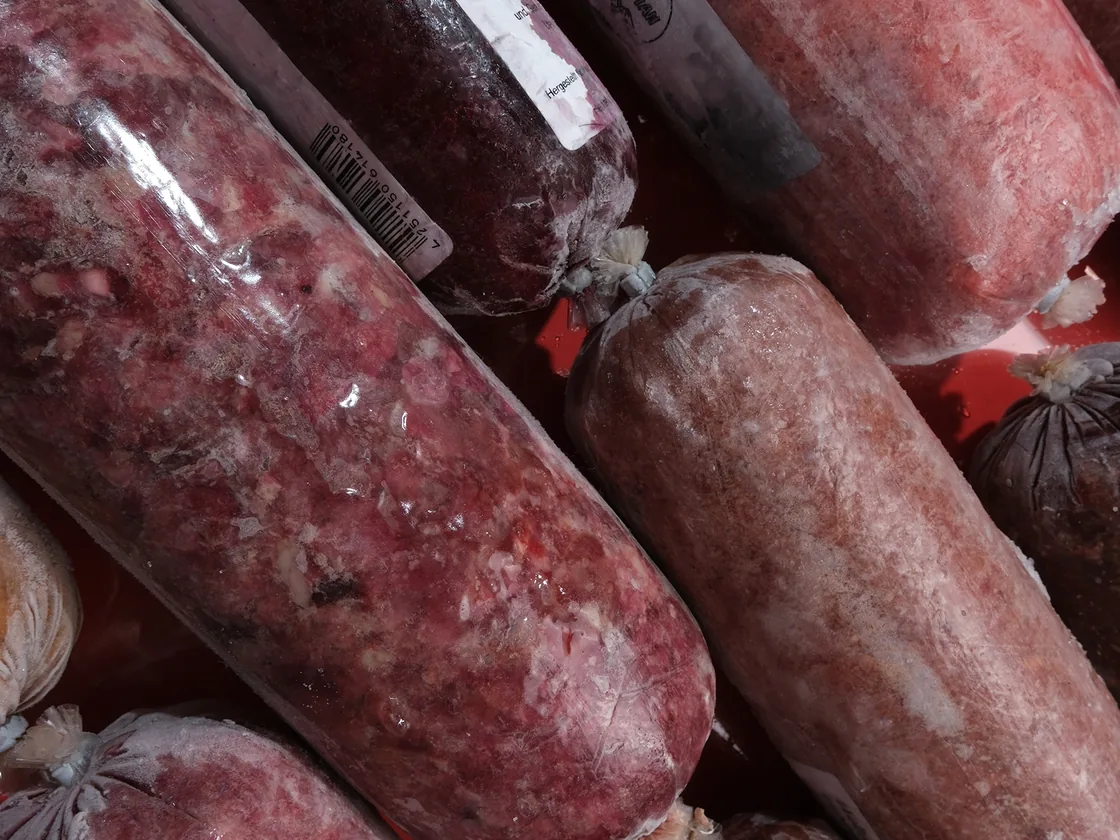 Gestapelte Frostfleisch-Rollen in der Tiefkühltruhe des Abholmarkts